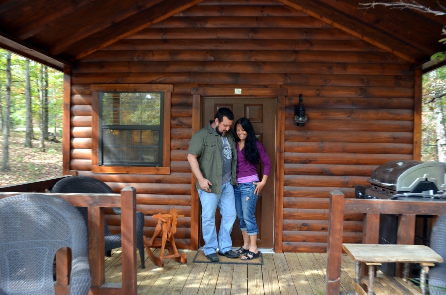 Bunny and Arvie Bennett embracing outside their tiny cabin.